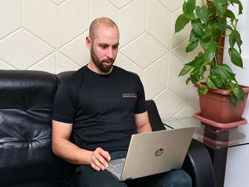 Man using laptop on couch