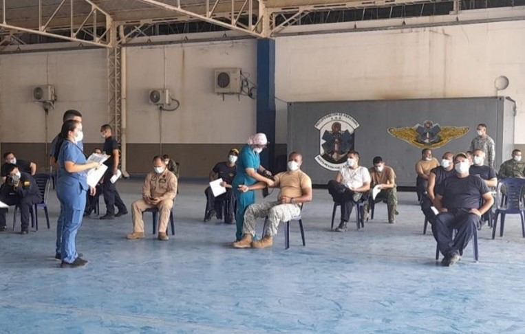 Rapid Response Team members (standing, left) assist with the COVID-19 vaccination process in Barranquilla, Colombia. 